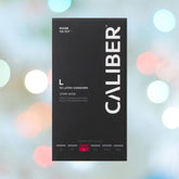 Caliber L - Large Condoms (57mm Wide) against a blurred, circular-lit background. Box labeled "Made to Fit," includes 12 latex condoms with sizes from S to 3XL indicated at the bottom.